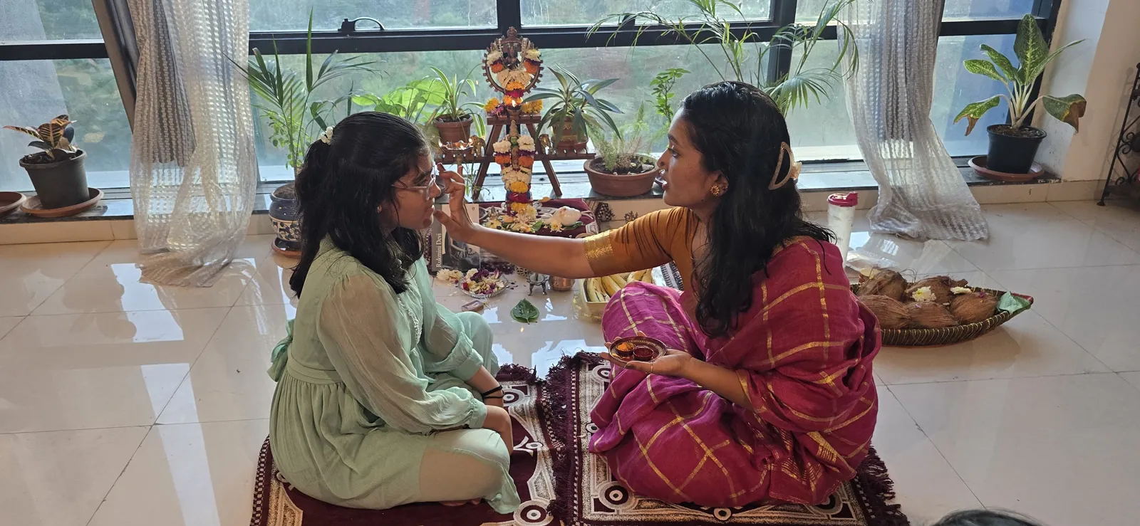 Teacher and student seated together for a ceremony