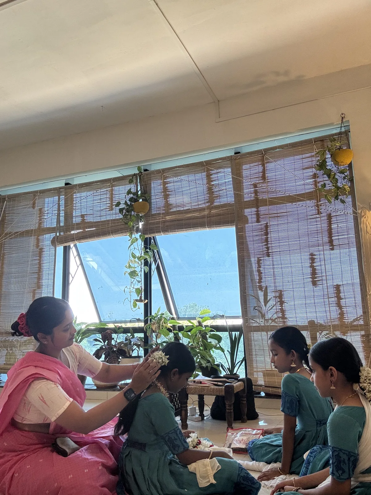 Srushti Loya getting students ready, with flowers in their hair
