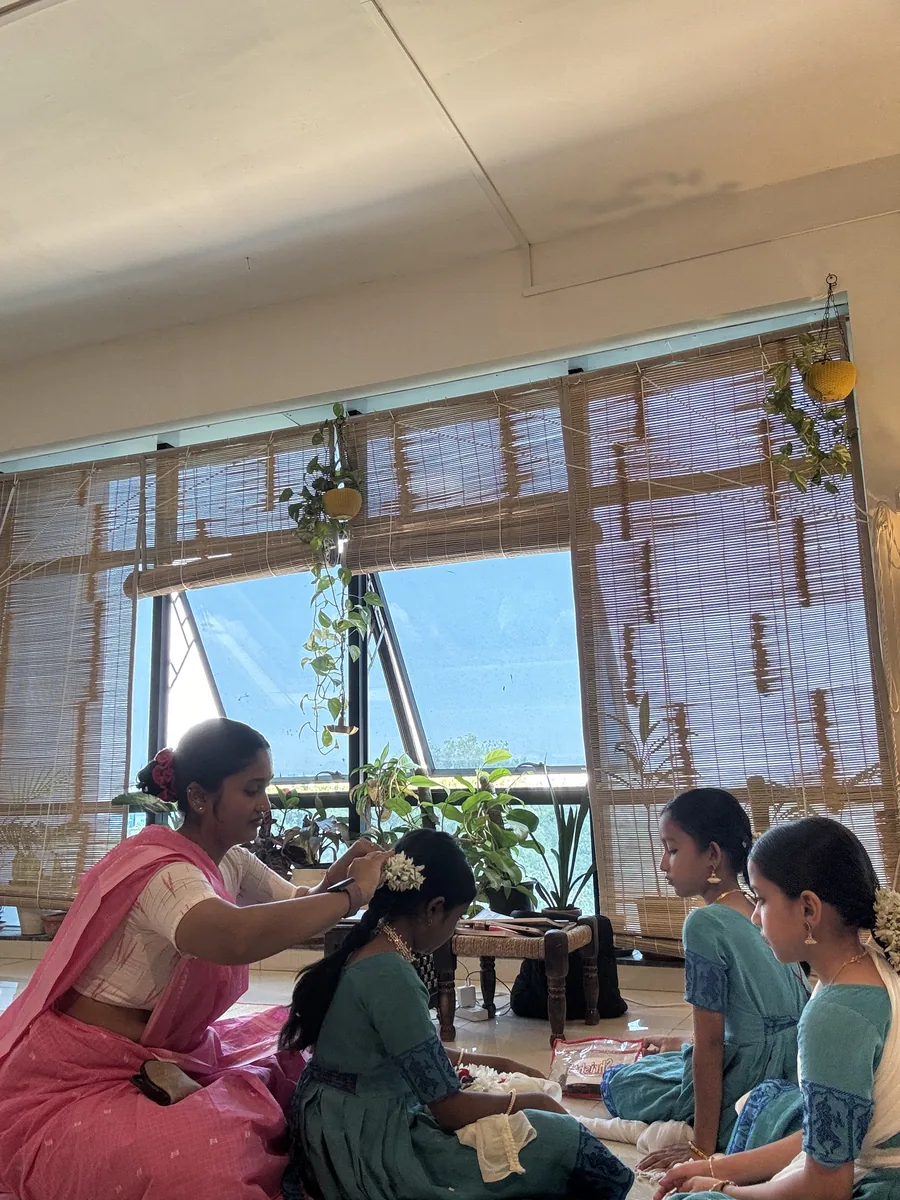Flowers being pinned into a student's hair