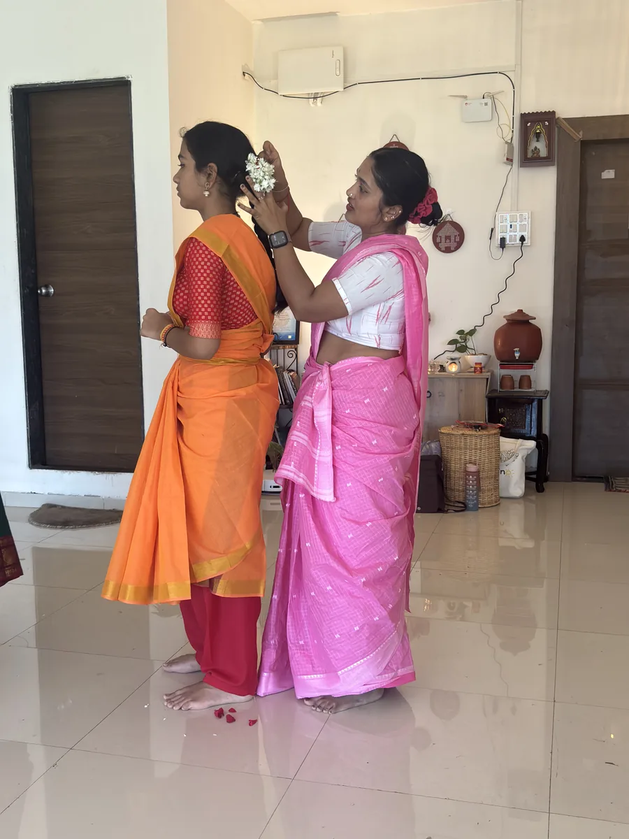 Helping a student drape her practice saree