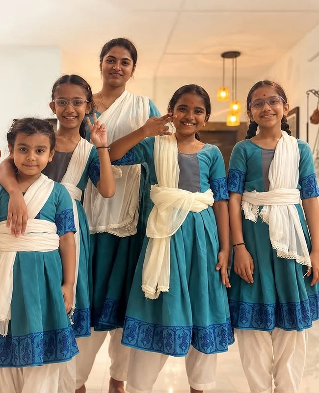 Young Indīvarā Arts students in their blue and white practice uniforms